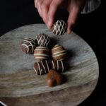 person holding chocolate ball