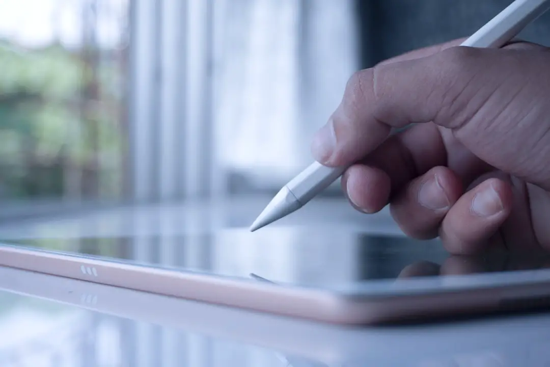 Writing on the iPad with an apple pencil.