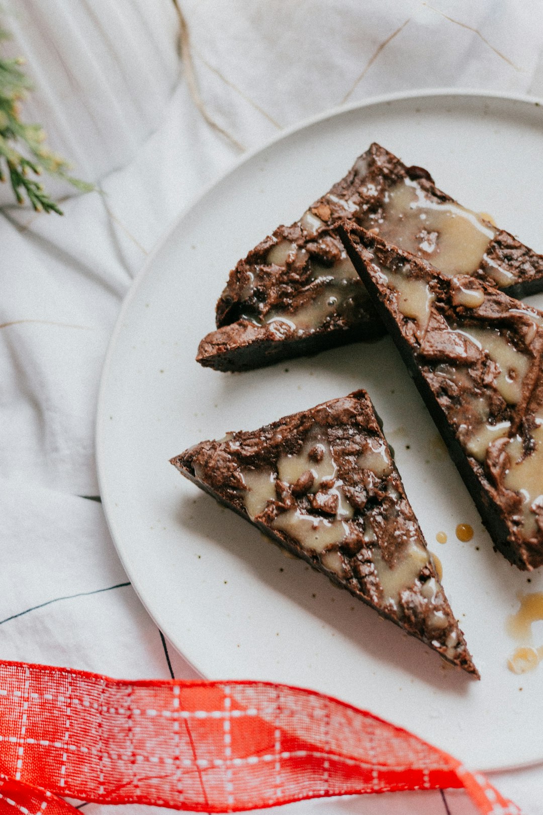 FAQ by Chocolate Brands sliced pizza on white ceramic plate
