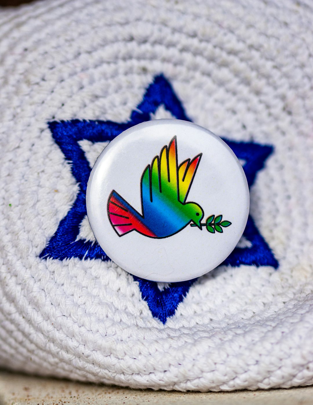 a white button with a colorful bird on it